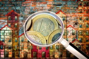 Public housing concept image painted on a old brick wall - Concept image seen through a magnifying glass with euro coins - I'm the copyright owner of the graffiti images used in this picture